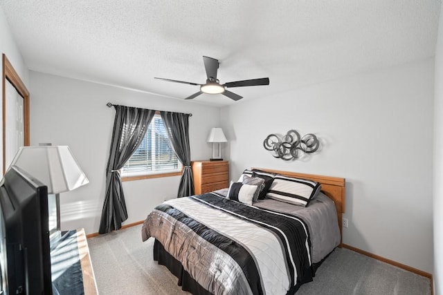 carpeted bedroom featuring a ceiling fan, baseboards, and a textured ceiling