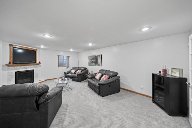 living room featuring a glass covered fireplace, carpet flooring, recessed lighting, and baseboards