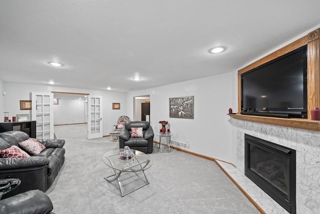 living area with recessed lighting, french doors, carpet flooring, a premium fireplace, and baseboards