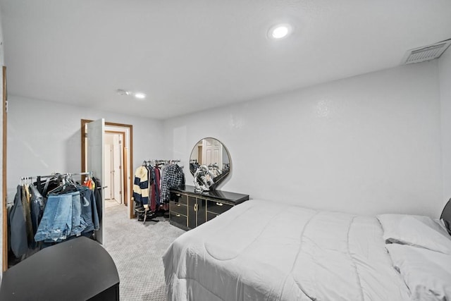 carpeted bedroom featuring visible vents