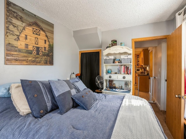 bedroom with carpet flooring and a textured ceiling