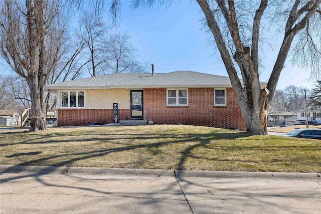 single story home featuring brick siding and a front yard