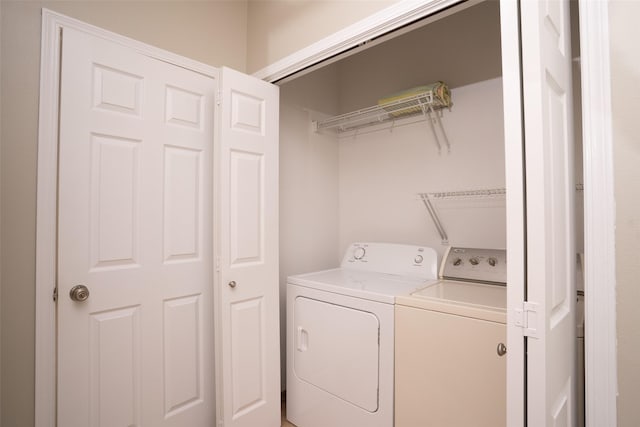 washroom with washer and clothes dryer and laundry area