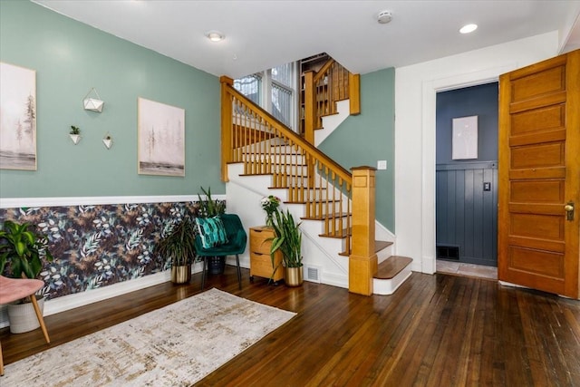 entryway featuring stairway, visible vents, and hardwood / wood-style floors