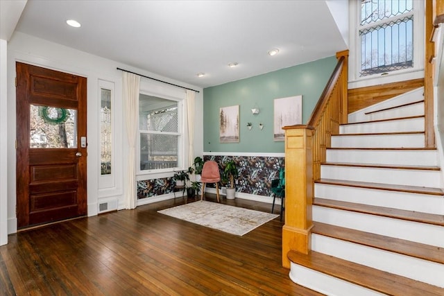 foyer featuring hardwood / wood-style floors, stairway, visible vents, baseboards, and recessed lighting