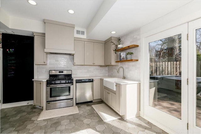 kitchen featuring decorative backsplash, light countertops, visible vents, and appliances with stainless steel finishes