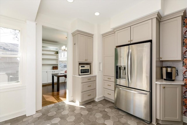 kitchen with gray cabinets, stainless steel refrigerator with ice dispenser, recessed lighting, light countertops, and light tile patterned floors