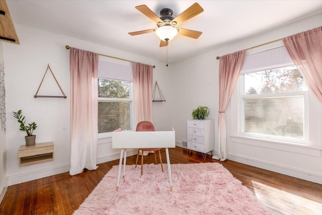 office area with ceiling fan, baseboards, and wood finished floors