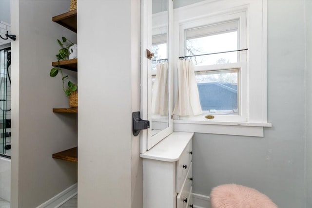 bathroom with baseboards and enclosed tub / shower combo