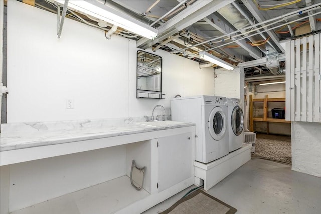 washroom with washer and clothes dryer, laundry area, and a sink