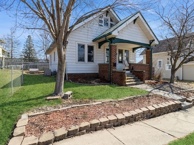 bungalow with a front lawn and fence