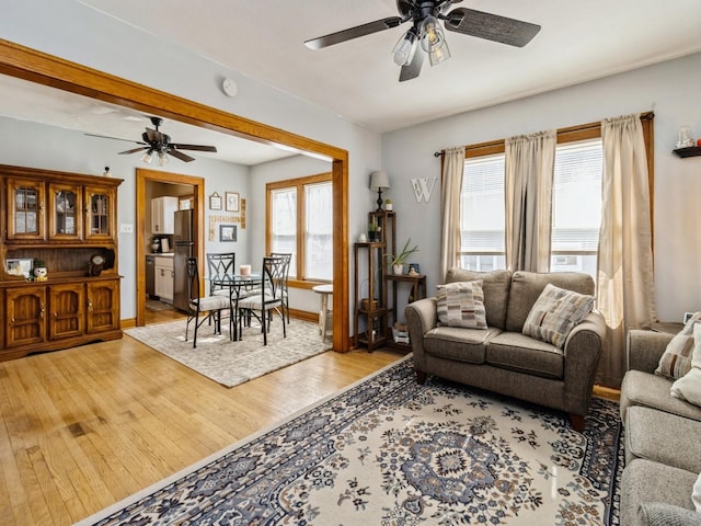 410 1st St S, Newton, IA 50208 - living room with light wood-type flooring, a ceiling fan, and baseboards