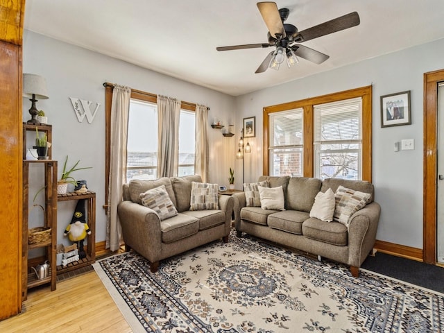410 1st St S, Newton, IA 50208 - living room with ceiling fan, baseboards, and light wood-type flooring