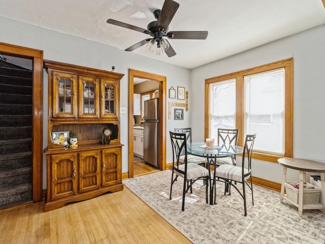 410 1st St S, Newton, IA 50208 - dining room with stairs, a ceiling fan, baseboards, and light wood finished floors
