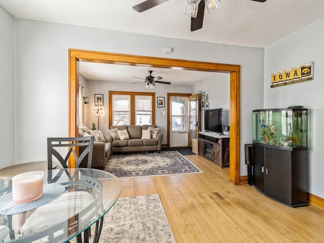 410 1st St S, Newton, IA 50208 - living area featuring ceiling fan, baseboards, and light wood-type flooring