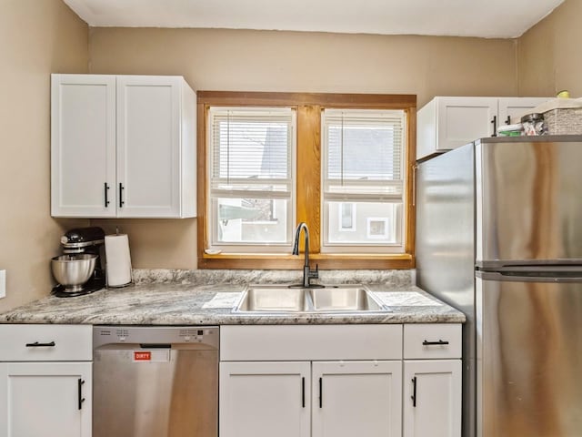 410 1st St S, Newton, IA 50208 - kitchen with a sink, white cabinetry, and stainless steel appliances