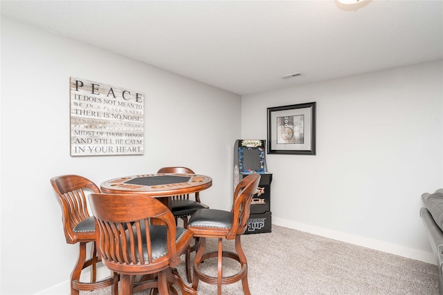 dining area with visible vents, baseboards, and carpet