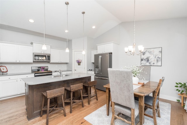 dining space with high vaulted ceiling, light wood-style flooring, recessed lighting, baseboards, and a chandelier