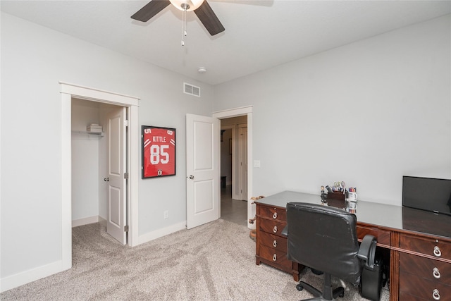 carpeted home office with visible vents, baseboards, and ceiling fan