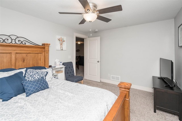 bedroom featuring visible vents, baseboards, light colored carpet, and ceiling fan