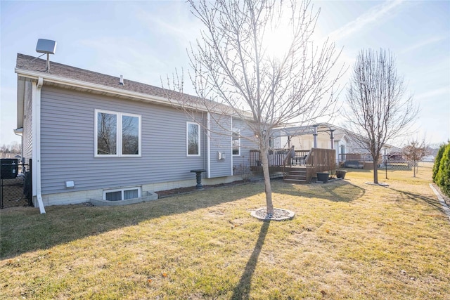 rear view of house featuring a yard, fence, a pergola, and a wooden deck