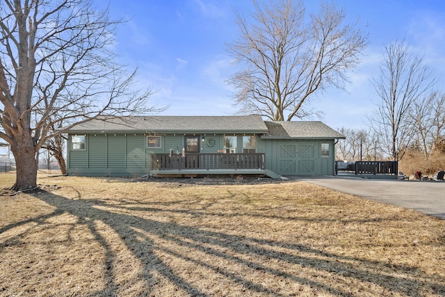 ranch-style home featuring board and batten siding and a wooden deck