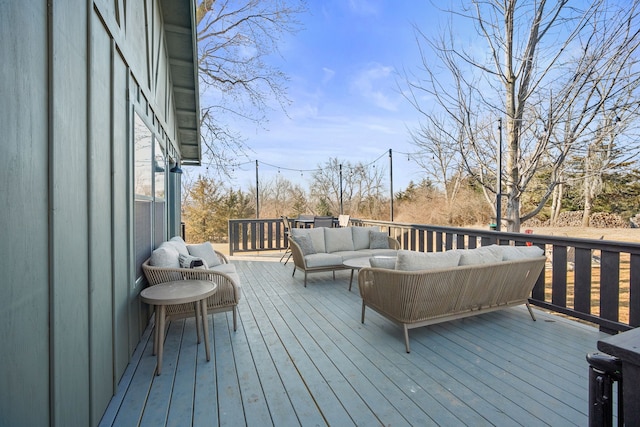 wooden terrace with an outdoor hangout area