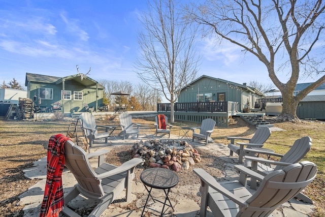 view of patio featuring a wooden deck and an outdoor fire pit