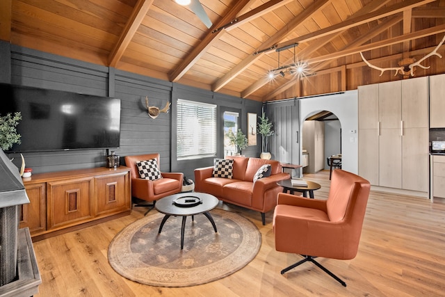 living room featuring arched walkways, light wood finished floors, wooden ceiling, and lofted ceiling with beams