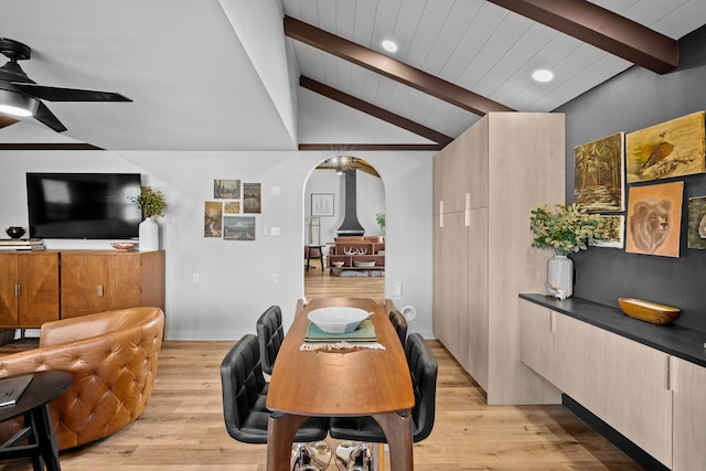 home office with recessed lighting, arched walkways, light wood-style floors, ceiling fan, and vaulted ceiling with beams