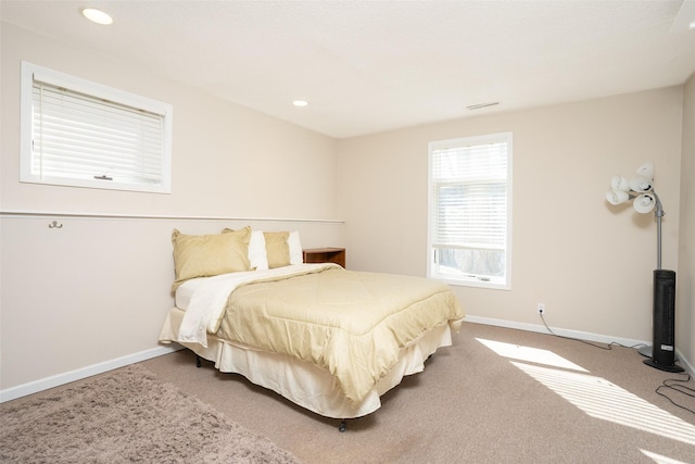 carpeted bedroom featuring visible vents, recessed lighting, and baseboards