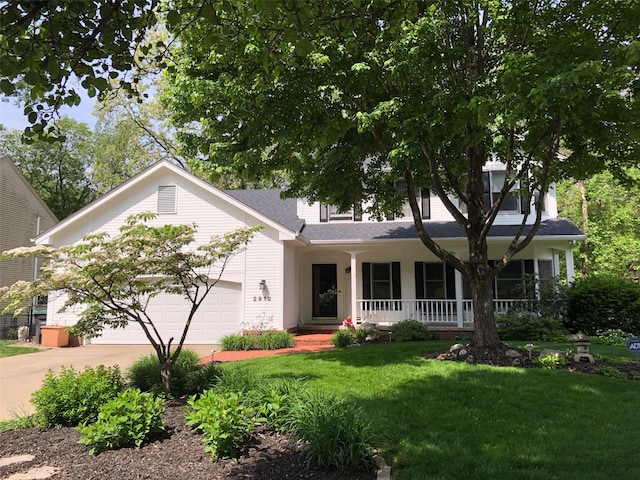 ranch-style house featuring roof with shingles, a porch, an attached garage, concrete driveway, and a front lawn