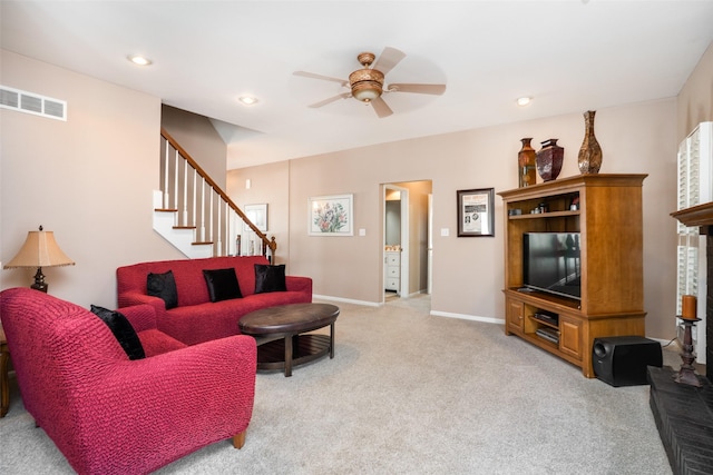 living area featuring baseboards, stairway, light colored carpet, recessed lighting, and a ceiling fan