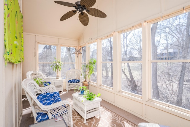 sunroom with ceiling fan and vaulted ceiling