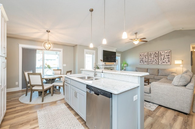 kitchen featuring a sink, light wood-style floors, dishwasher, and open floor plan