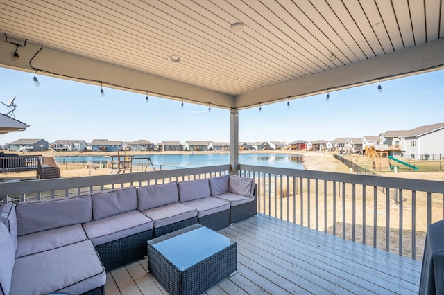 wooden terrace featuring a residential view, an outdoor hangout area, a playground, and a water view