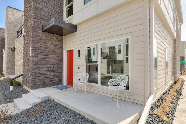 view of exterior entry featuring stone siding