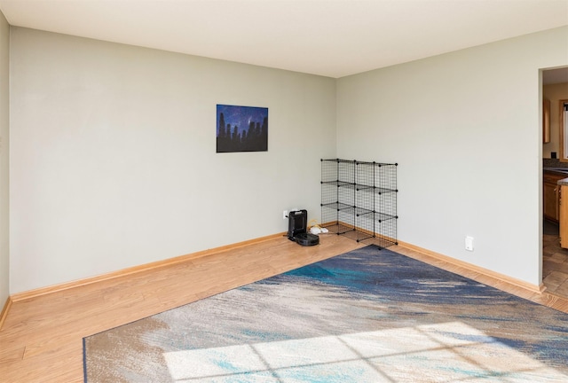 interior space with baseboards and wood finished floors