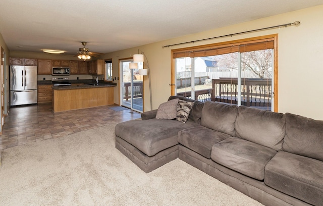 living area featuring a ceiling fan