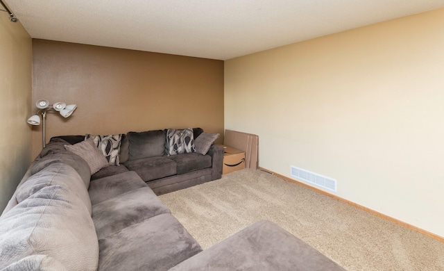 living area with visible vents, baseboards, and carpet