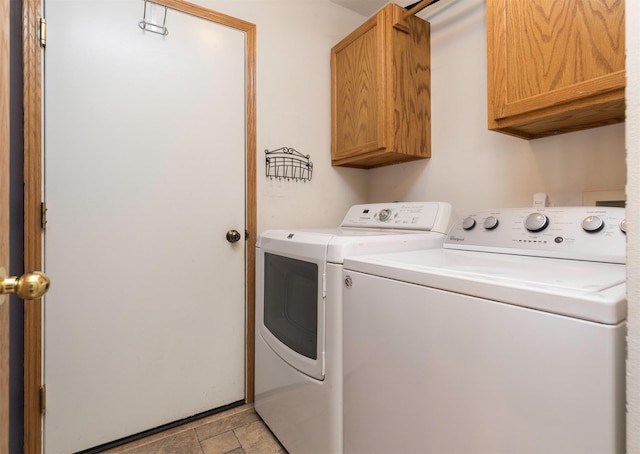 washroom featuring cabinet space and independent washer and dryer