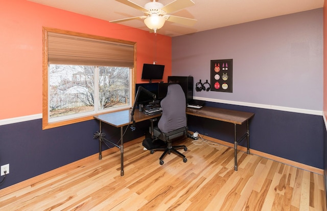 office area with ceiling fan, baseboards, and wood finished floors