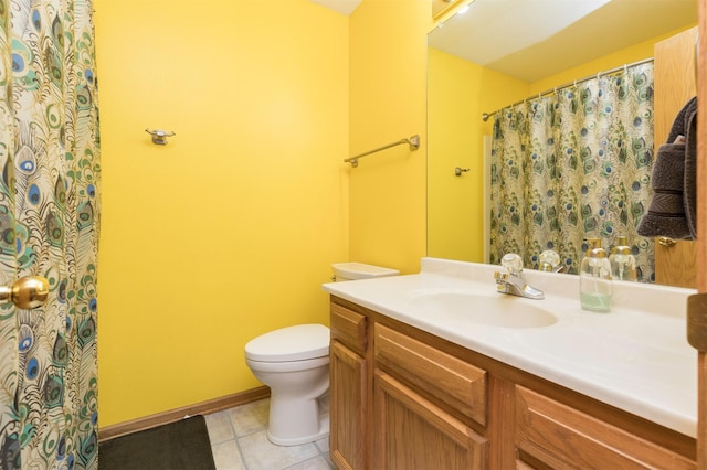 bathroom featuring vanity, a shower with shower curtain, baseboards, tile patterned floors, and toilet