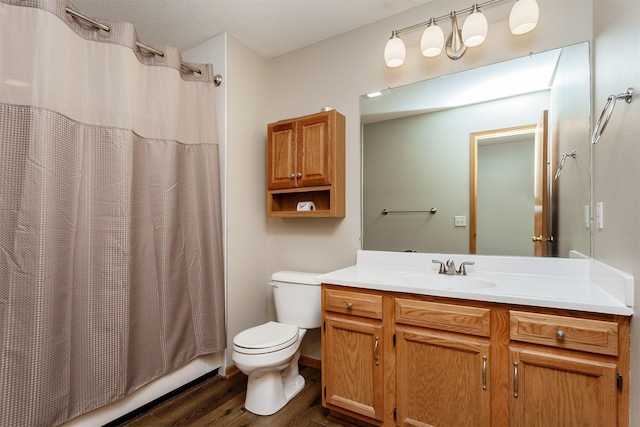 full bath featuring shower / bath combo with shower curtain, toilet, vanity, and wood finished floors