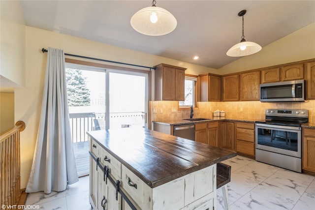 kitchen with backsplash, marble finish floor, appliances with stainless steel finishes, and a sink