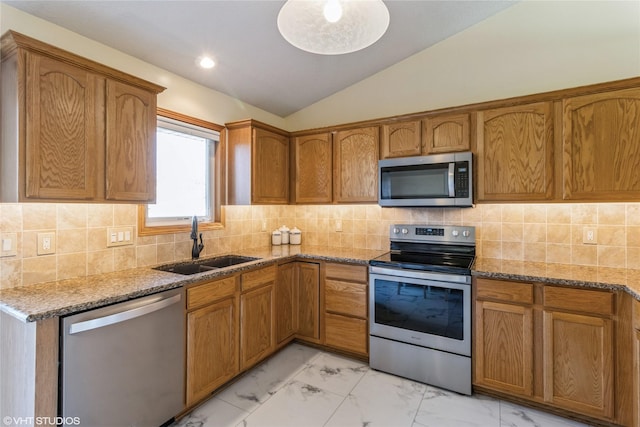 kitchen featuring marble finish floor, a sink, light stone counters, stainless steel appliances, and lofted ceiling