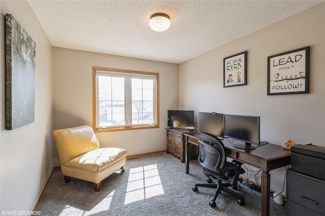 carpeted office space with baseboards and a textured ceiling