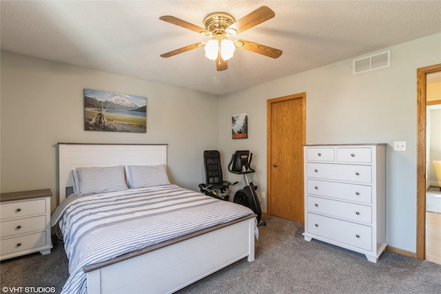 carpeted bedroom featuring visible vents, baseboards, a textured ceiling, and ceiling fan