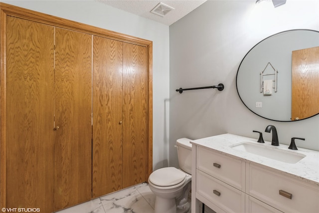 bathroom featuring vanity, visible vents, a textured ceiling, toilet, and marble finish floor