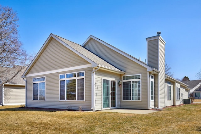 back of house featuring a yard, a patio, central AC unit, and a chimney